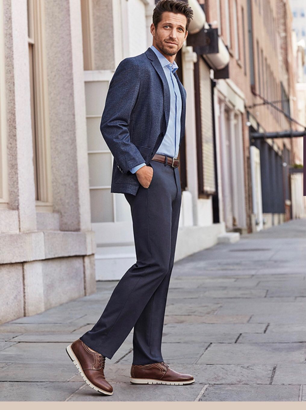 Man wearing navy suit with gray pants & loafers