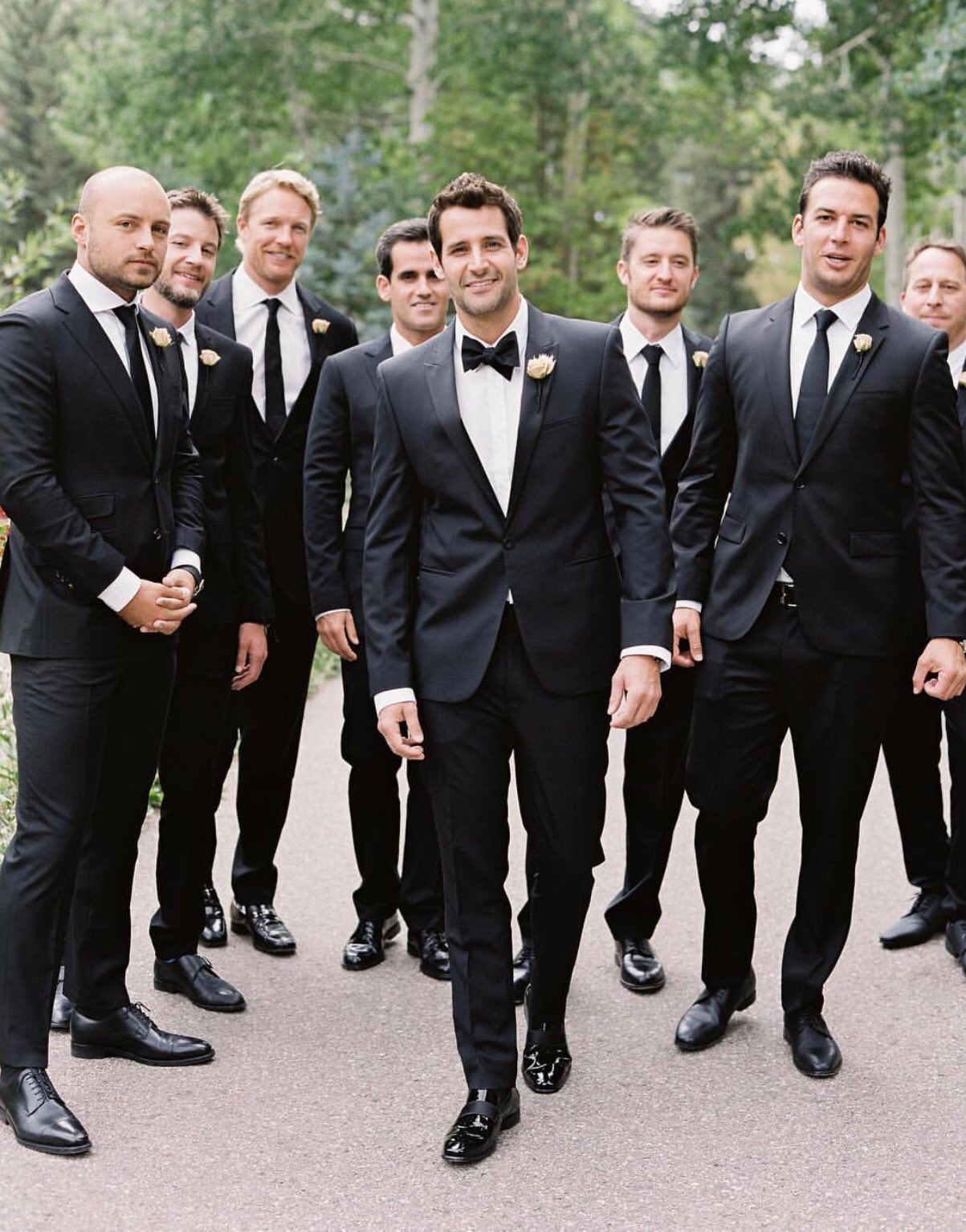 Groom and groomsmen in perfectly tailored bespoke tuxedos