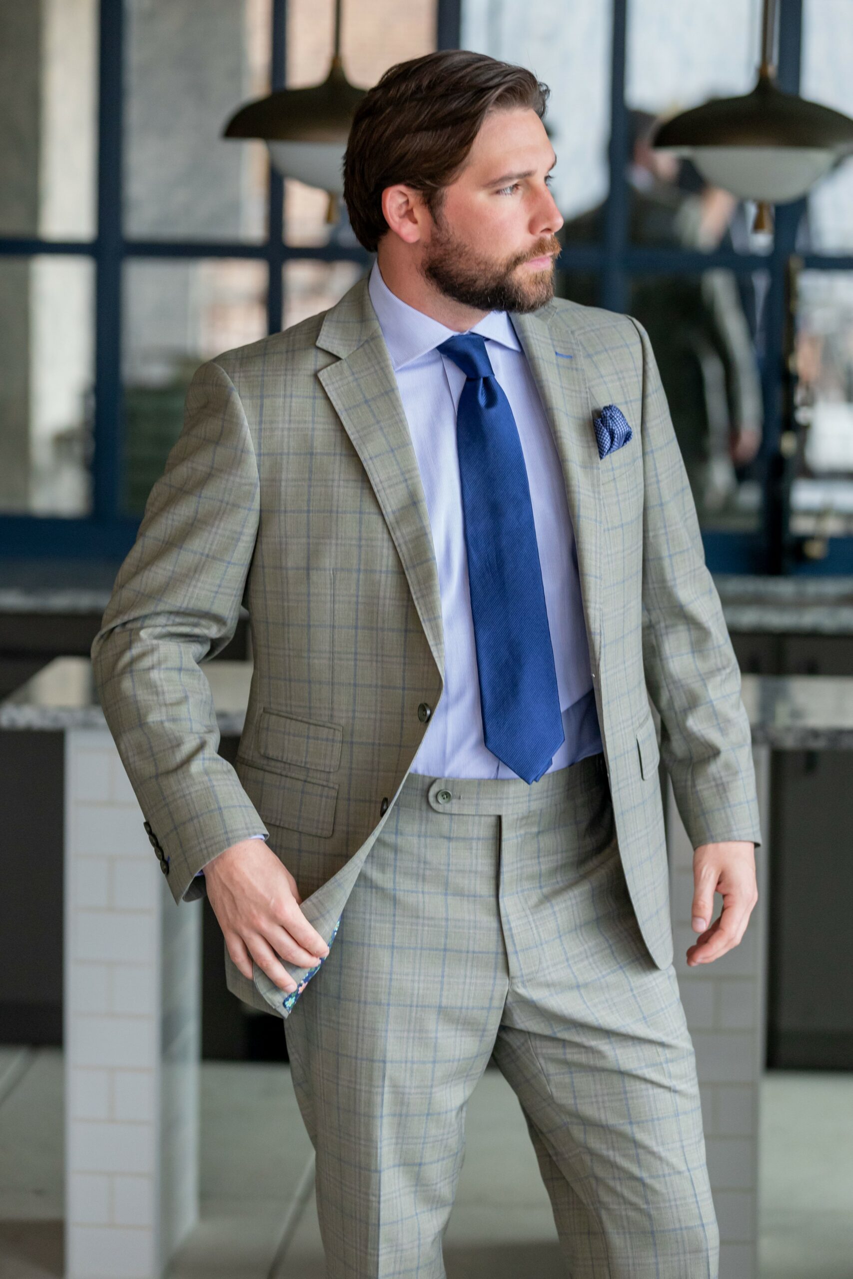Spring Summer version of Super 130’s wool stretch custom made suit in a tropical weave light grey with blue plaid