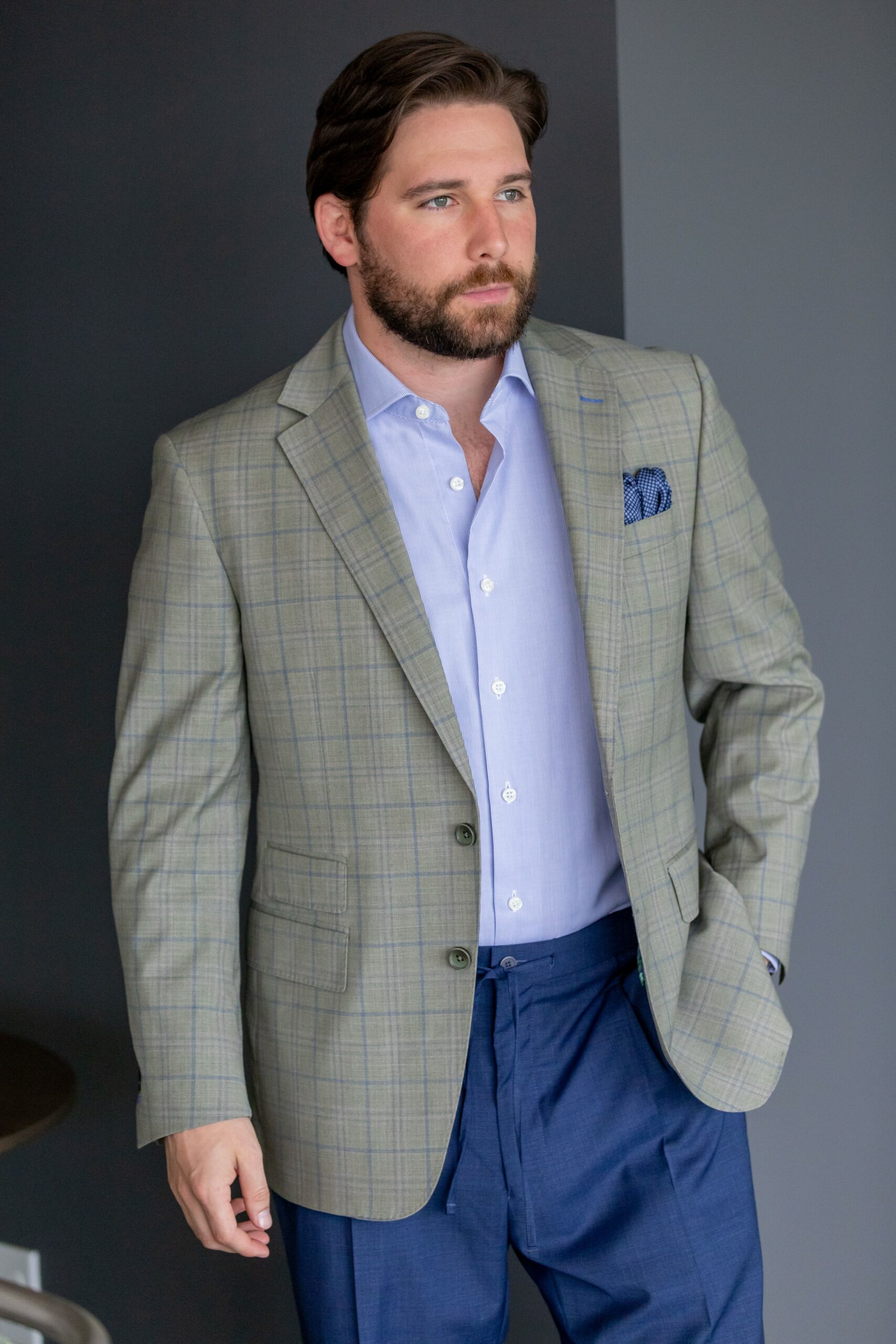 Spring Summer version of Super 130’s wool stretch custom made grey plaid sport coat and blue pants in a tropical weave